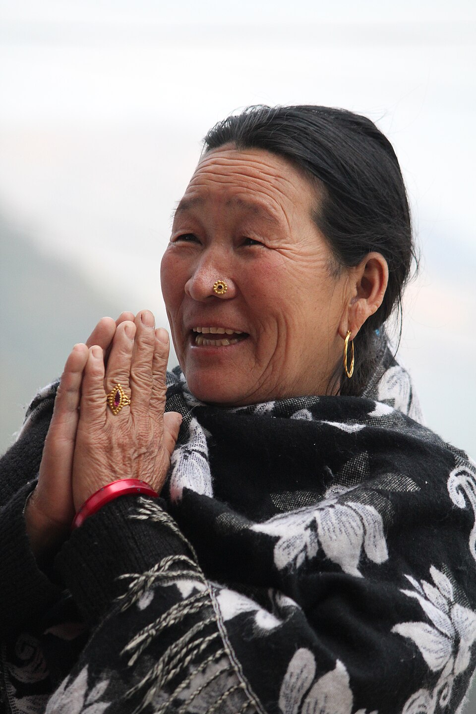 A woman greeting an acquaintance with joined palms in Okhaldhunga, Nepal