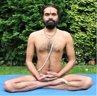 A seated Siddhasana demonstration; the still photograph does not establish a breathing technique