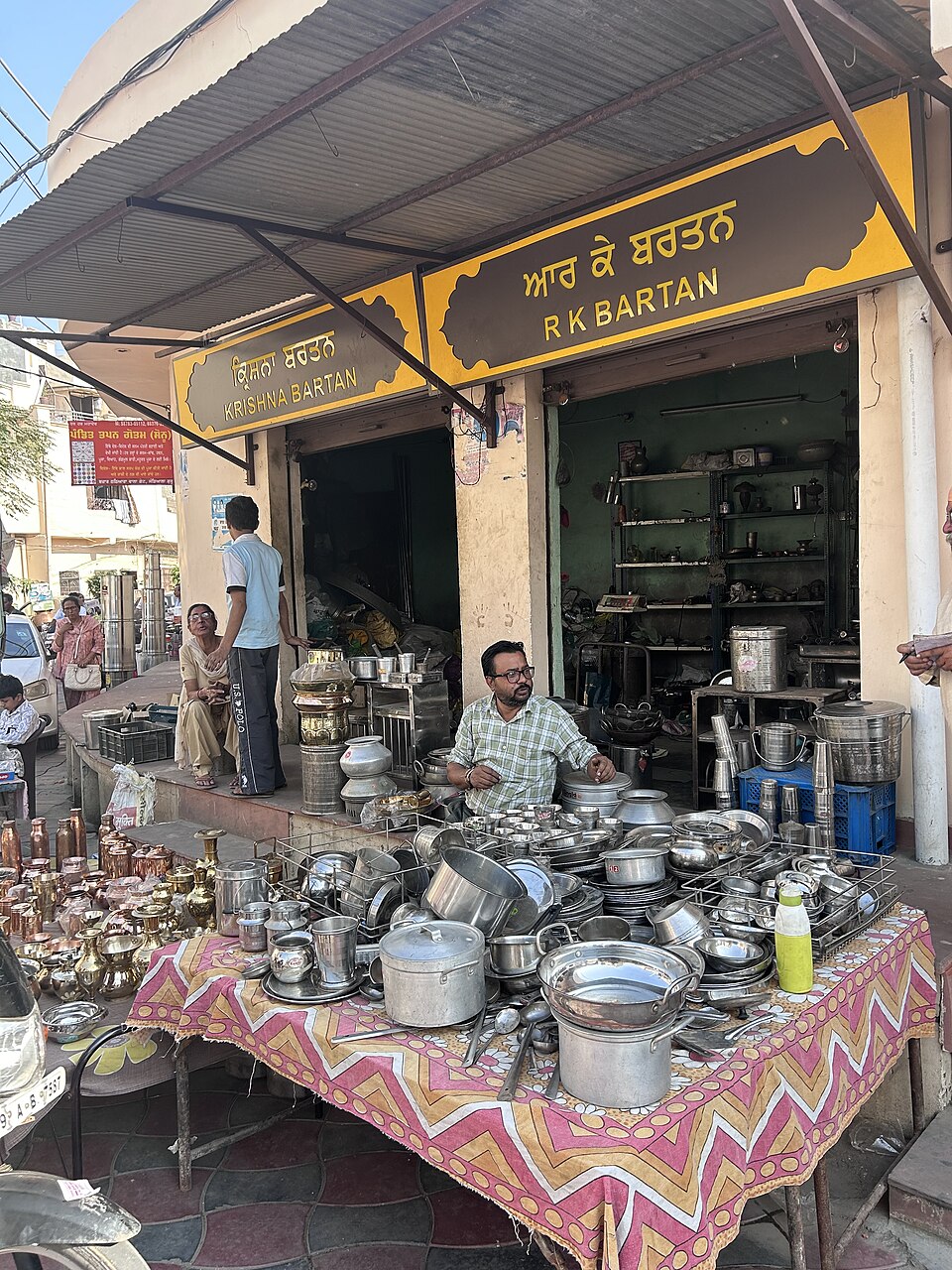 A utensil seller in the Thathera market at Jandiala Guru