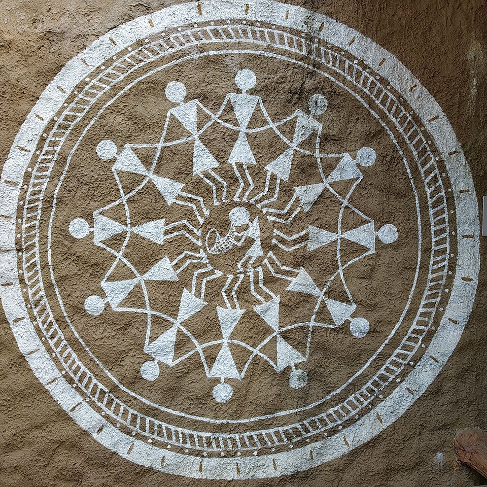 A Warli painting arranged around a circular composition
