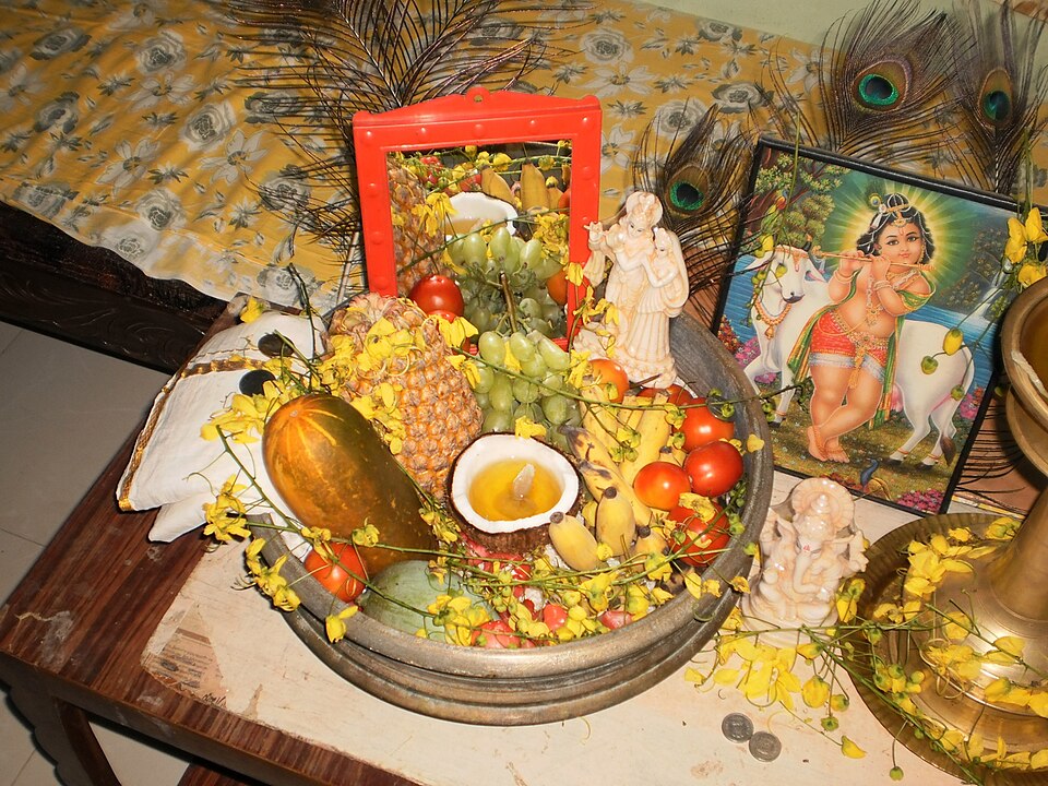 A Vishukkani arrangement with produce, lamps and devotional images