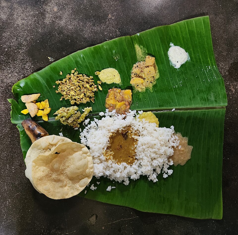 An Onam sadya served on a banana leaf at a Kerala home in 2024