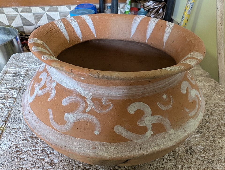 A decorated earthen vessel associated with Vishukkani; one object rather than the complete arrangement