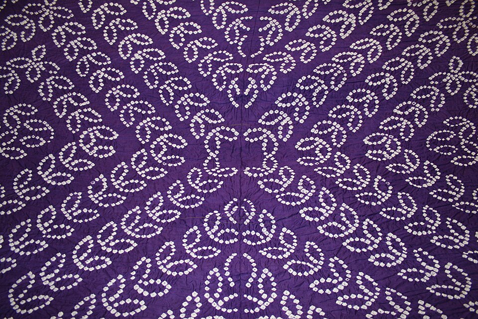 Bandhani work on a sari, showing the small resist-dyed marks